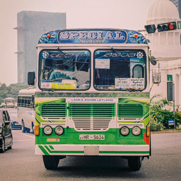 Analog travel photography print of a vintage Sri Lankan bus captured on Kodak Gold film with warm cinematic tones and nostalgic documentary texture.