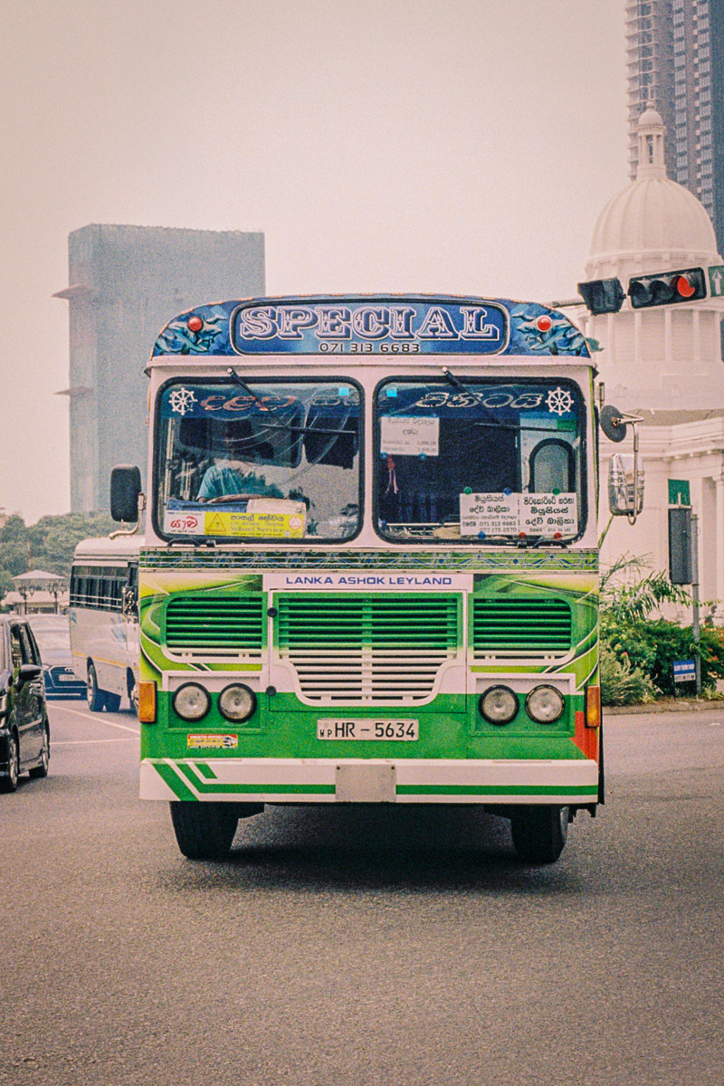 Analog travel photography print of a vintage Sri Lankan bus captured on Kodak Gold film with warm cinematic tones and nostalgic documentary texture.