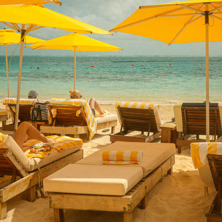 Puerto Morelos beach print featuring yellow umbrellas, striped loungers, and turquoise Caribbean water in Mexico.